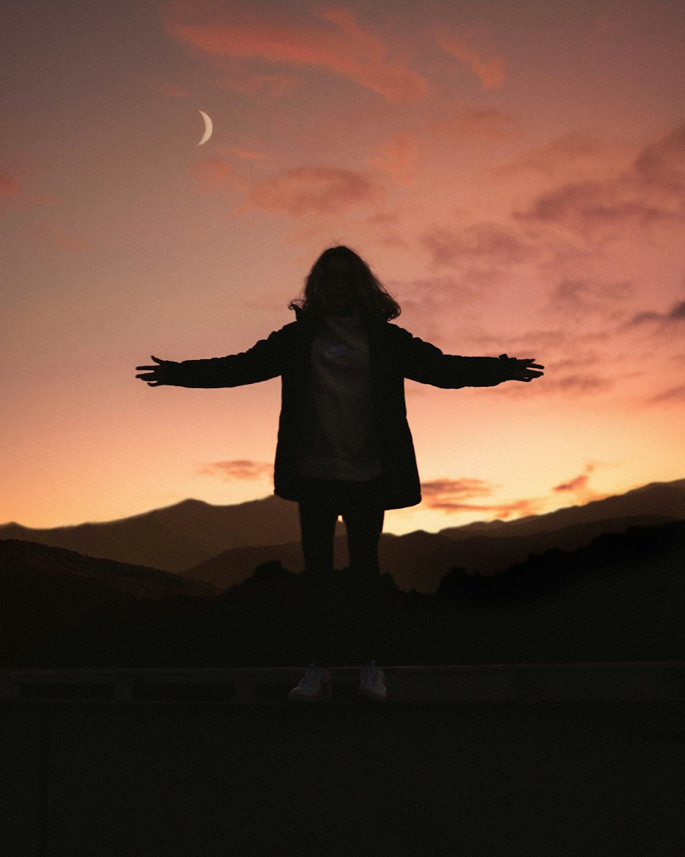 silhouette of woman on mountain