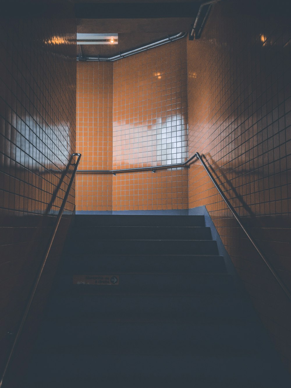 black stairs with gray handrail