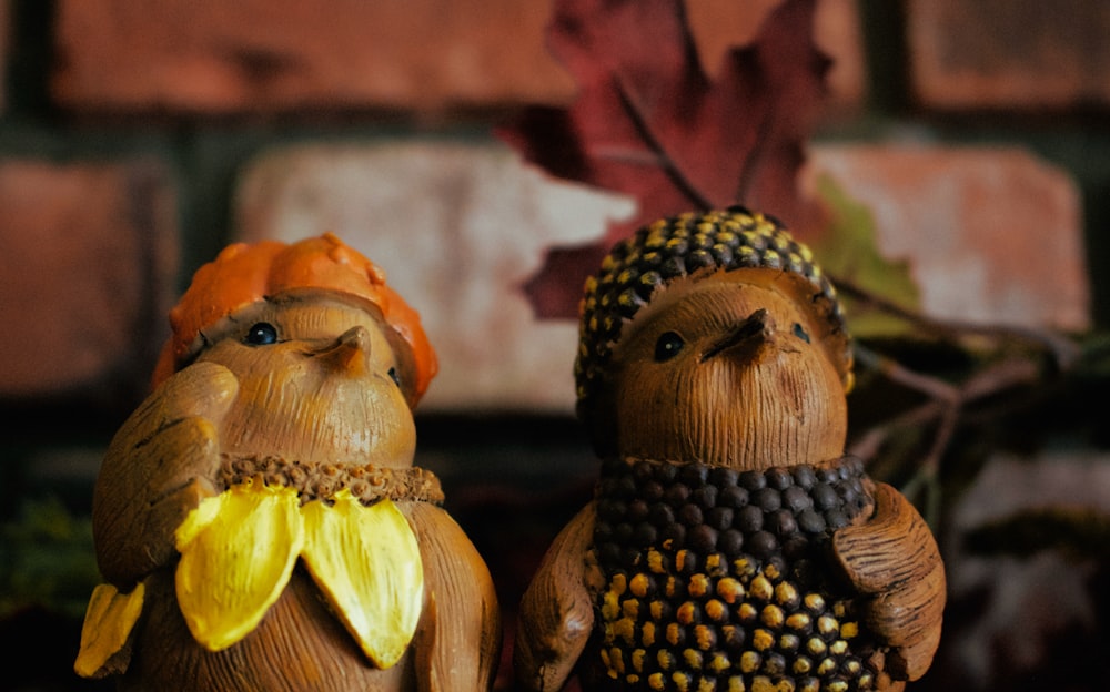 two brown wooden bird figurines