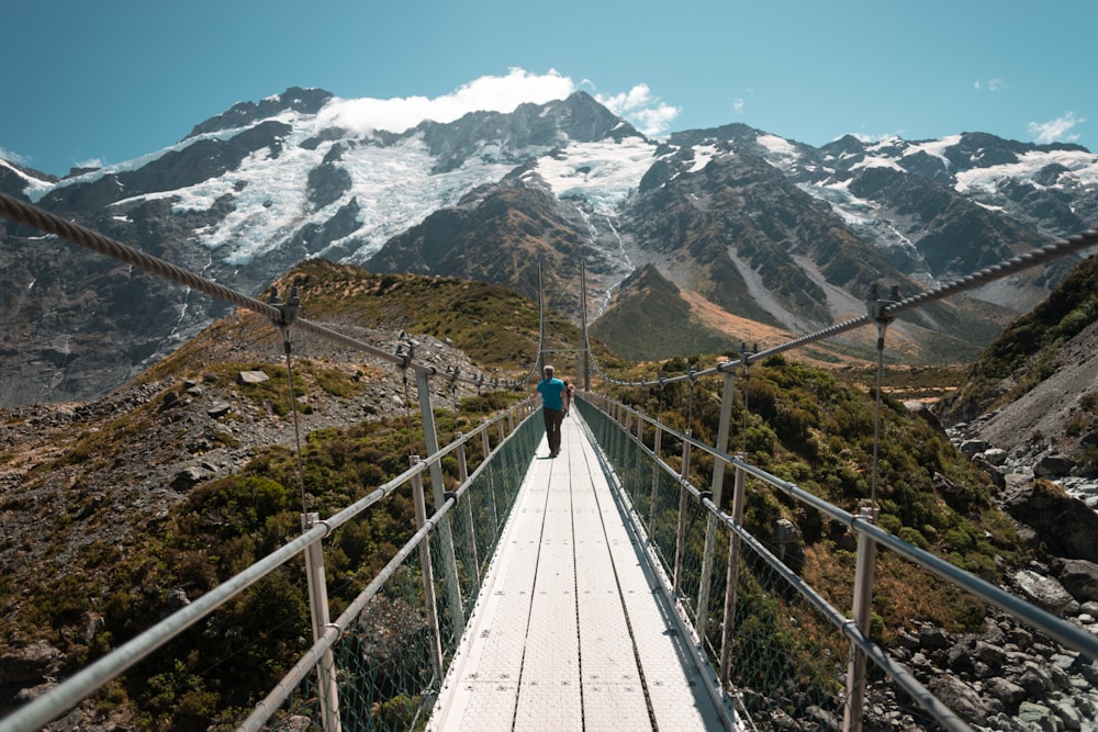 people on mountain bridge during day