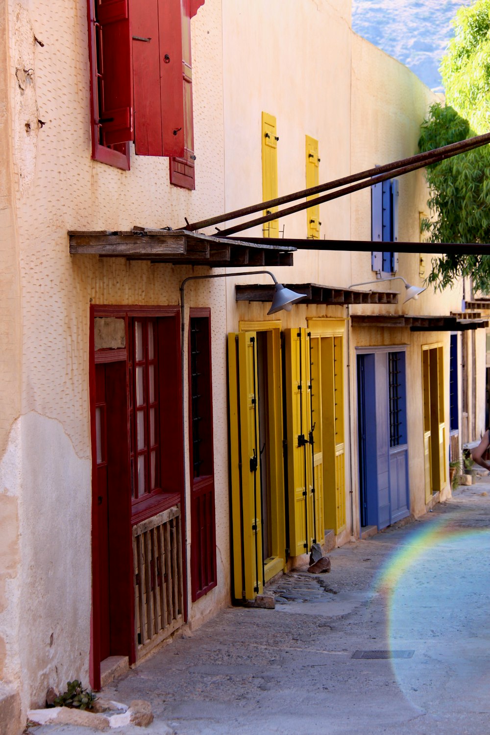 white building with assorted-colored wooden doors