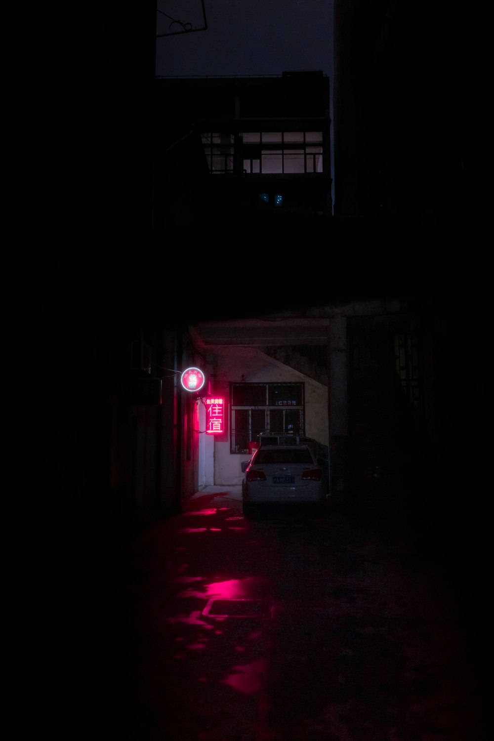 a car parked in front of a building at night