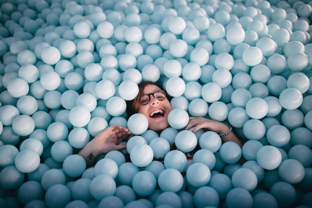 woman in pile of white balls