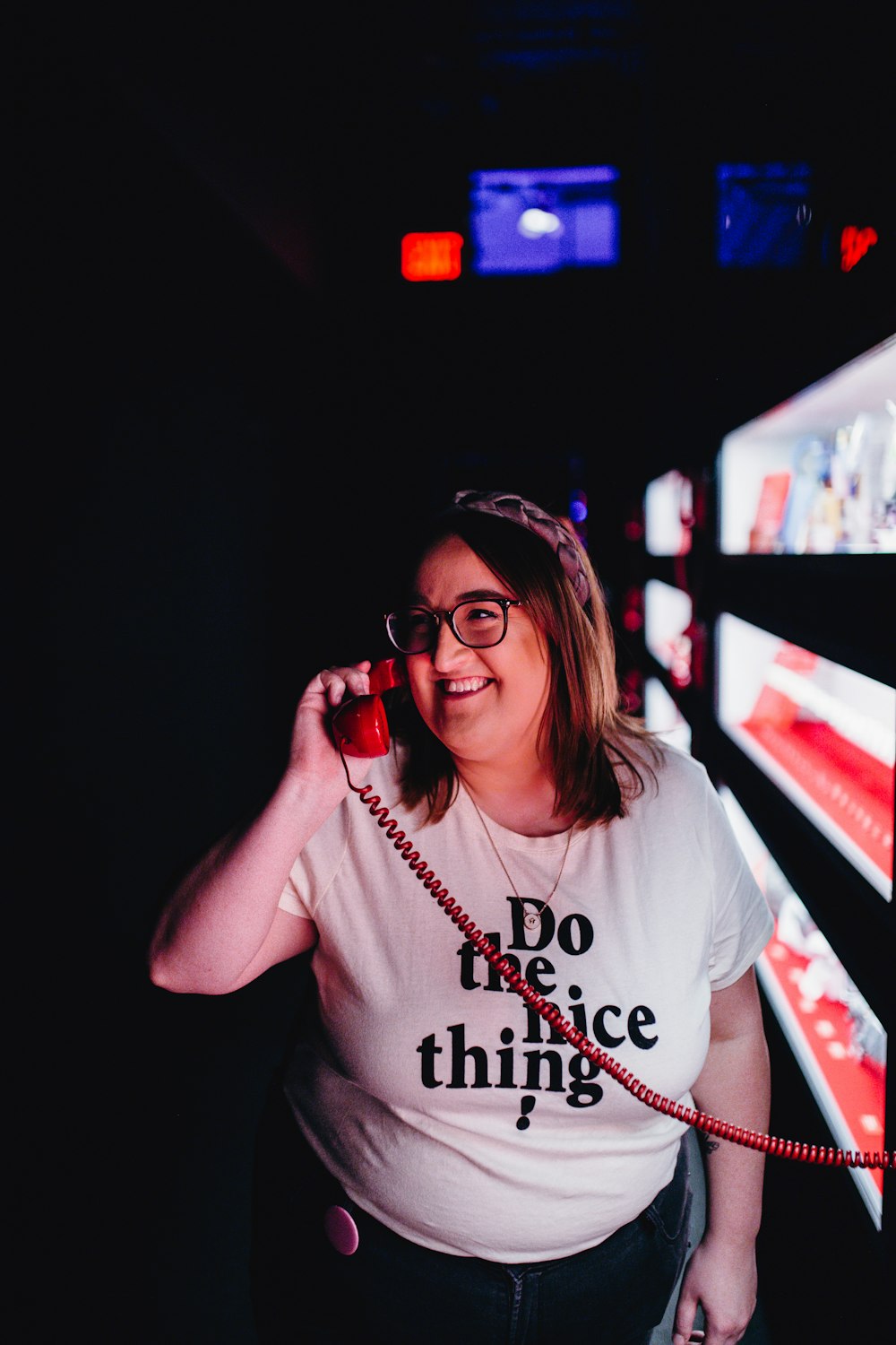 woman holding red telephone