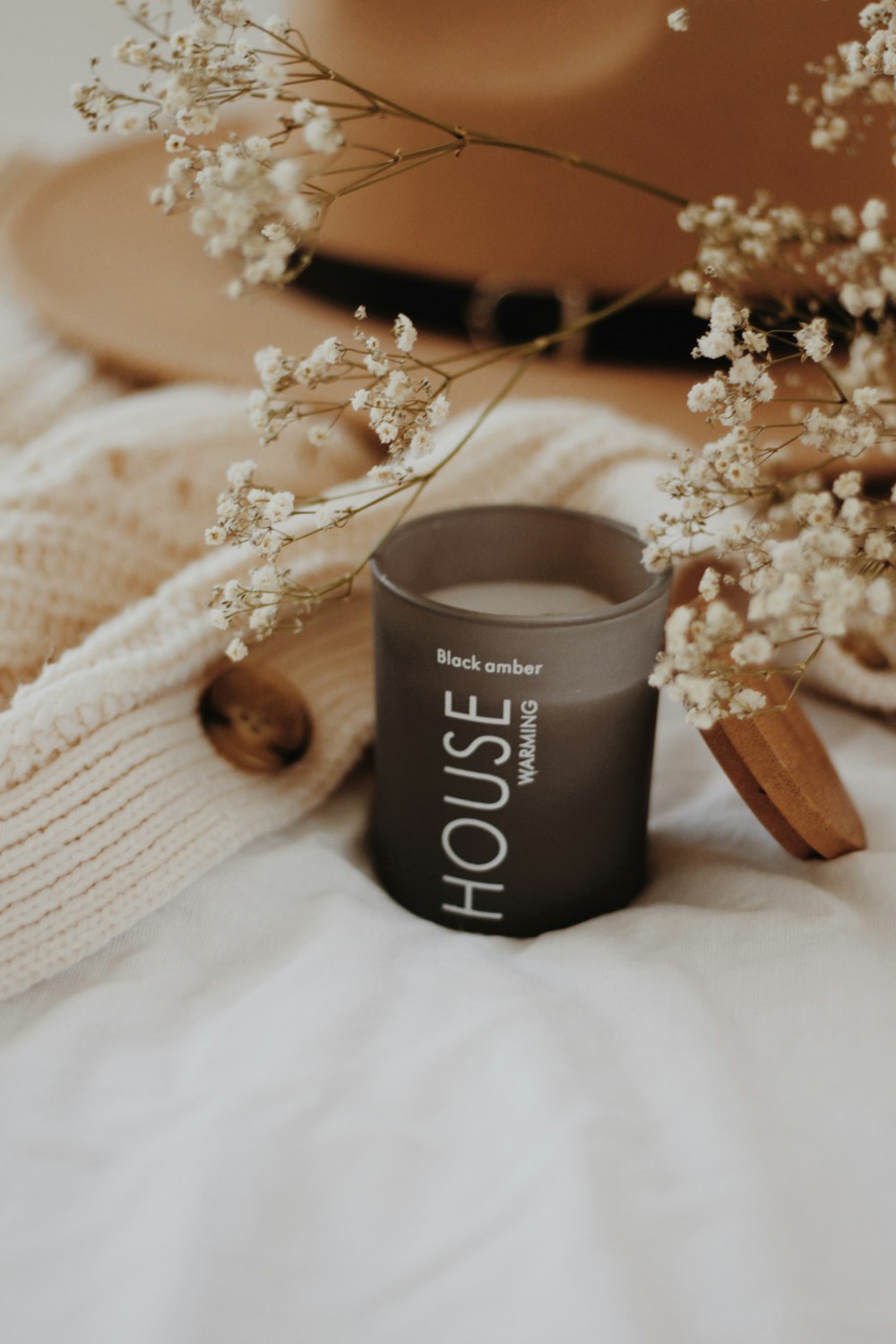 white petaled flowers beside cup