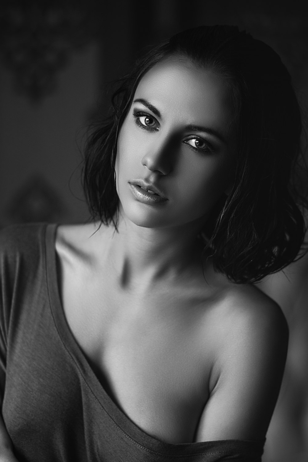 grayscale photo of woman in off-shoulder shirt