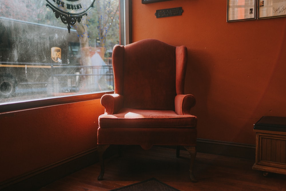 brown wooden framed red padded armchair