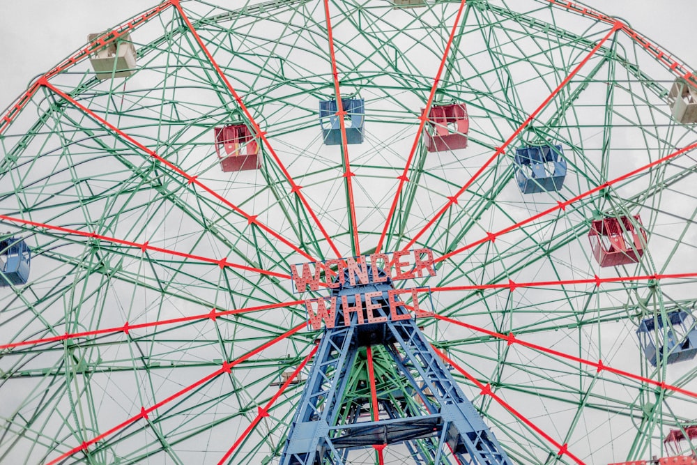 low-angle photography of red and blue Wonder Wheel Ferris wheel during daytime
