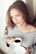 Image of a relaxed woman enjoying a cup of coffee, looking peaceful and happy.