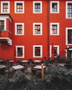 A vibrant café setting with outdoor seating and lush greenery.