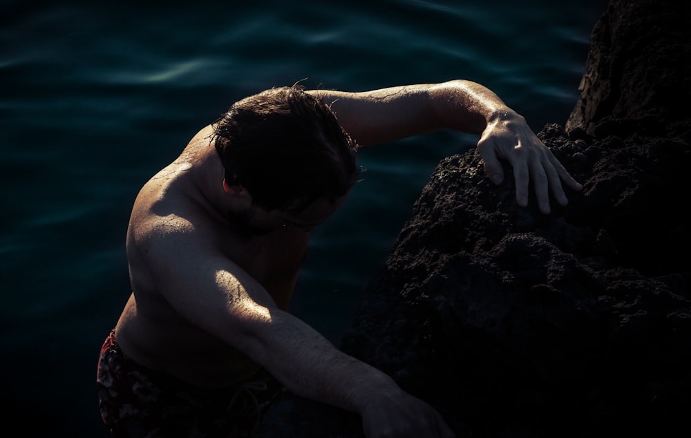 closeup photo of man climbing on rock