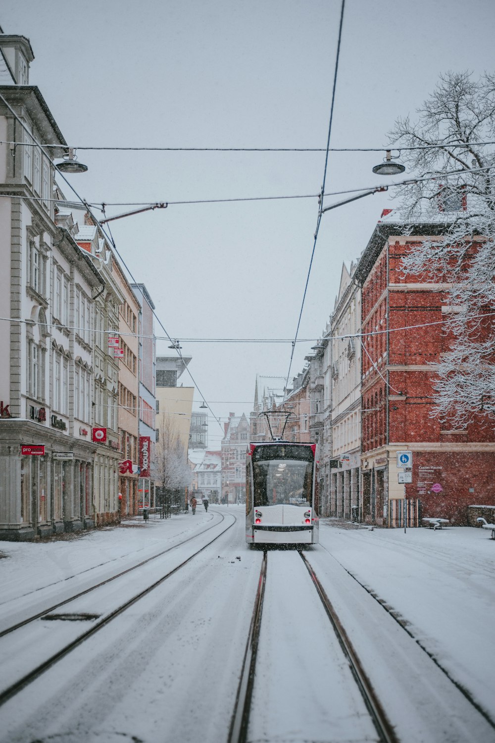 gray and red train near buildings