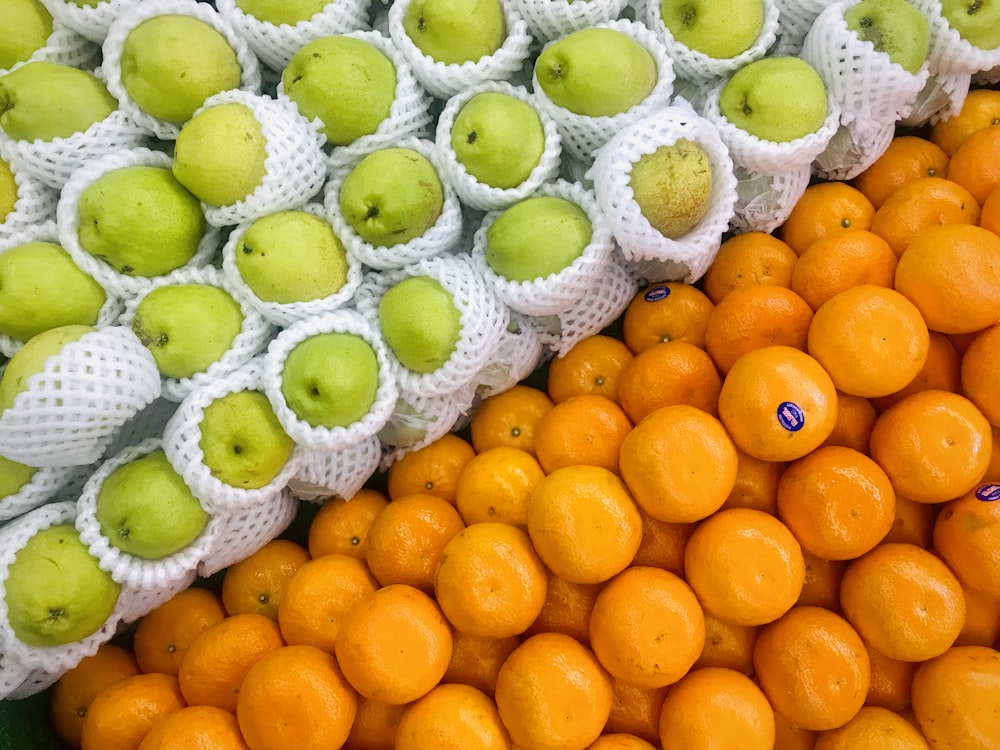 pile of green apples and orange fruits