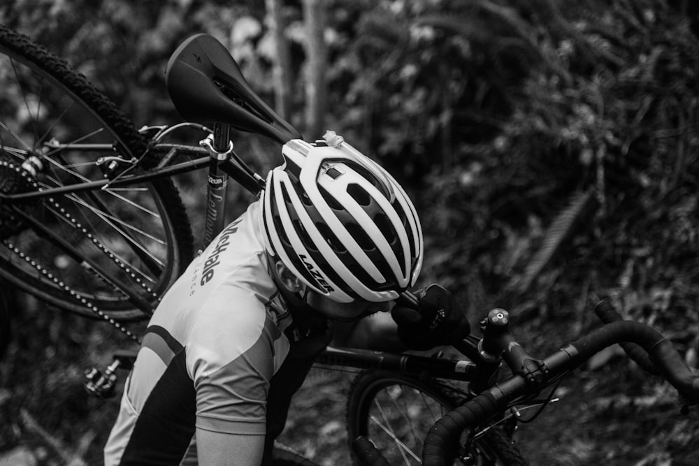 shallow focus photo of man carrying bike