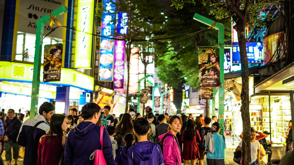 people gathering near buildings during night time