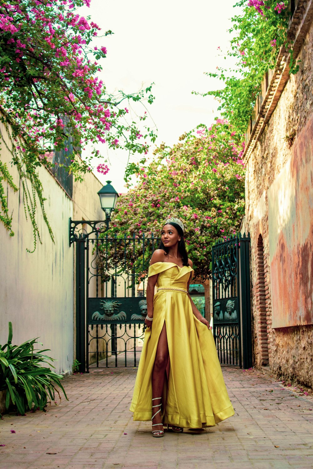 woman wearing yellow off-shoulder silt dress with tiara