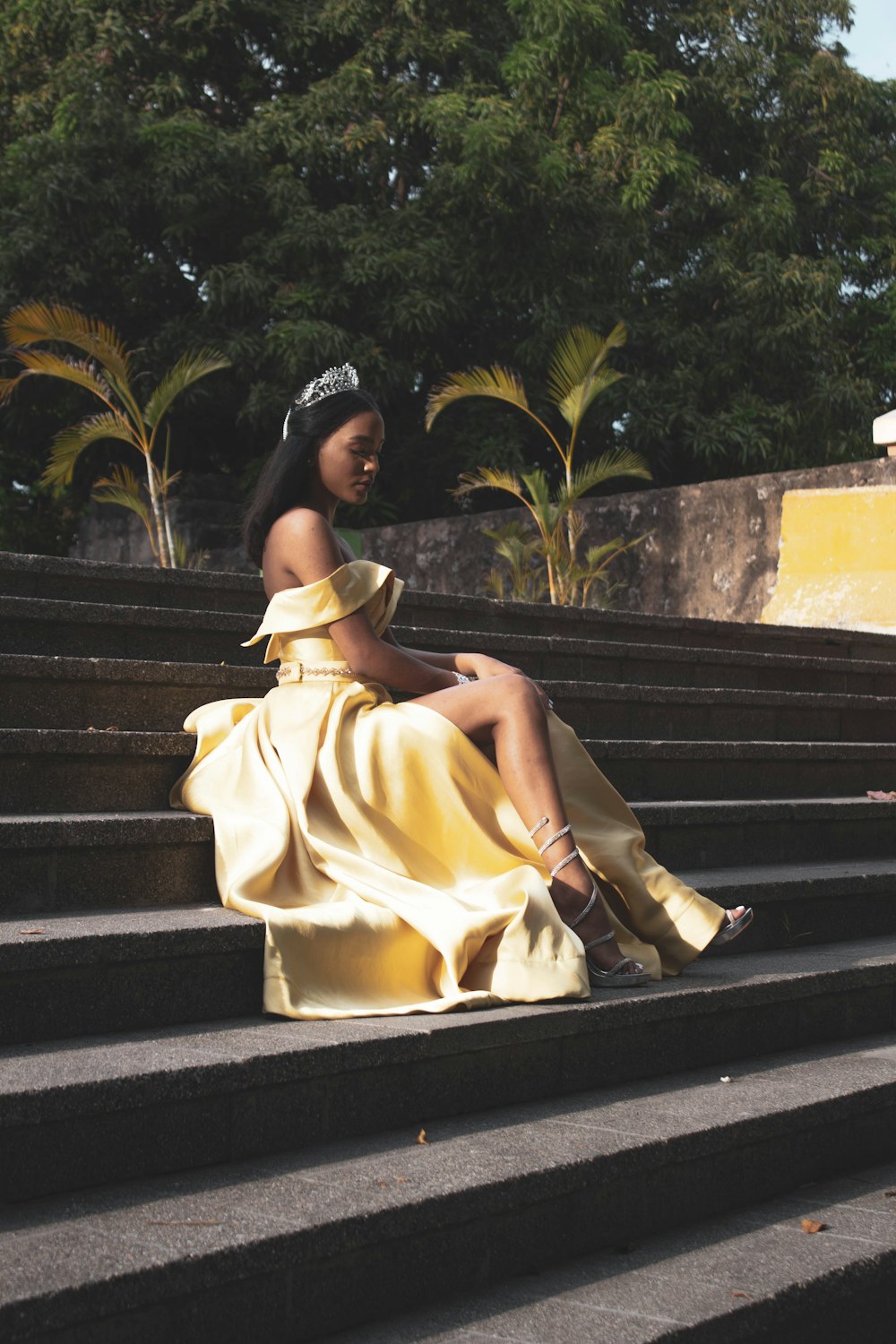 woman wearing yellow off-shoulder dress with silver tiara