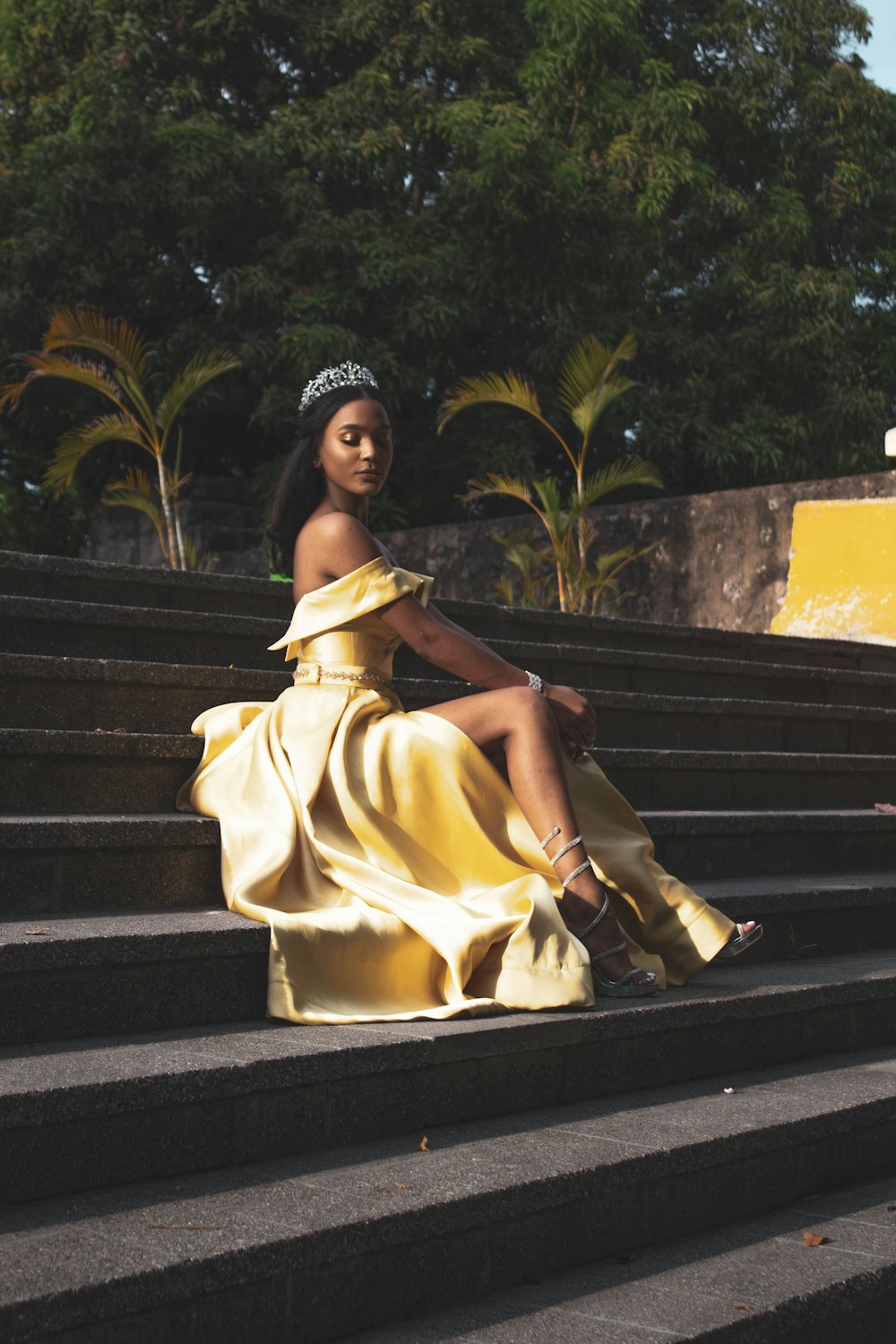woman in yellow dress sitting on stairs