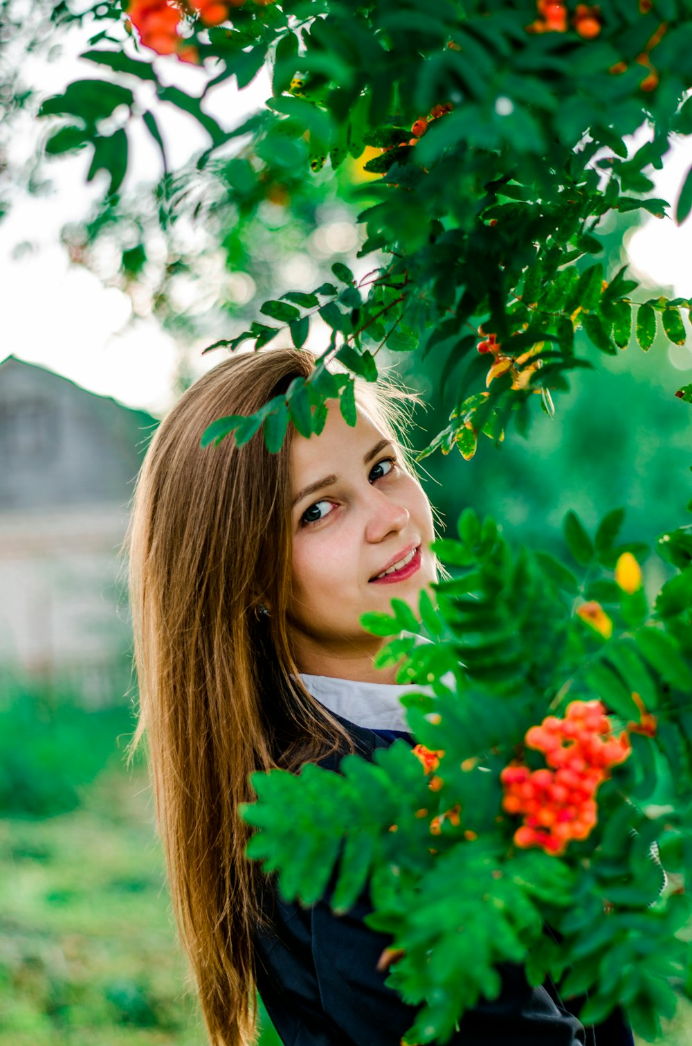 woman in black top beside plant