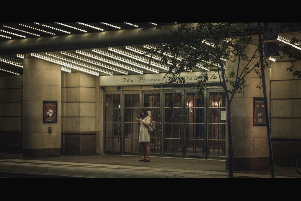 woman wearing white dress standing on street