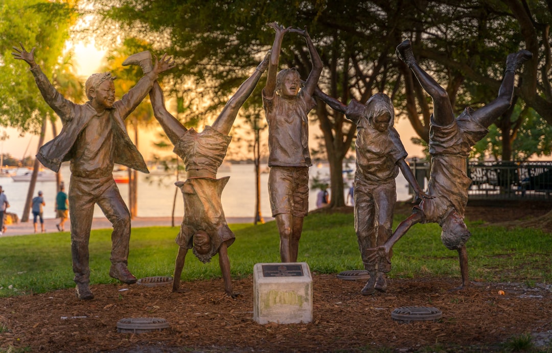 gold-colored statue of 5 person