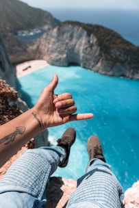 person sitting on cliff