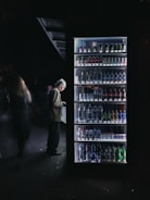 Technician performing maintenance on a vending machine in an office setting