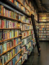 a long row of books on shelves in a library