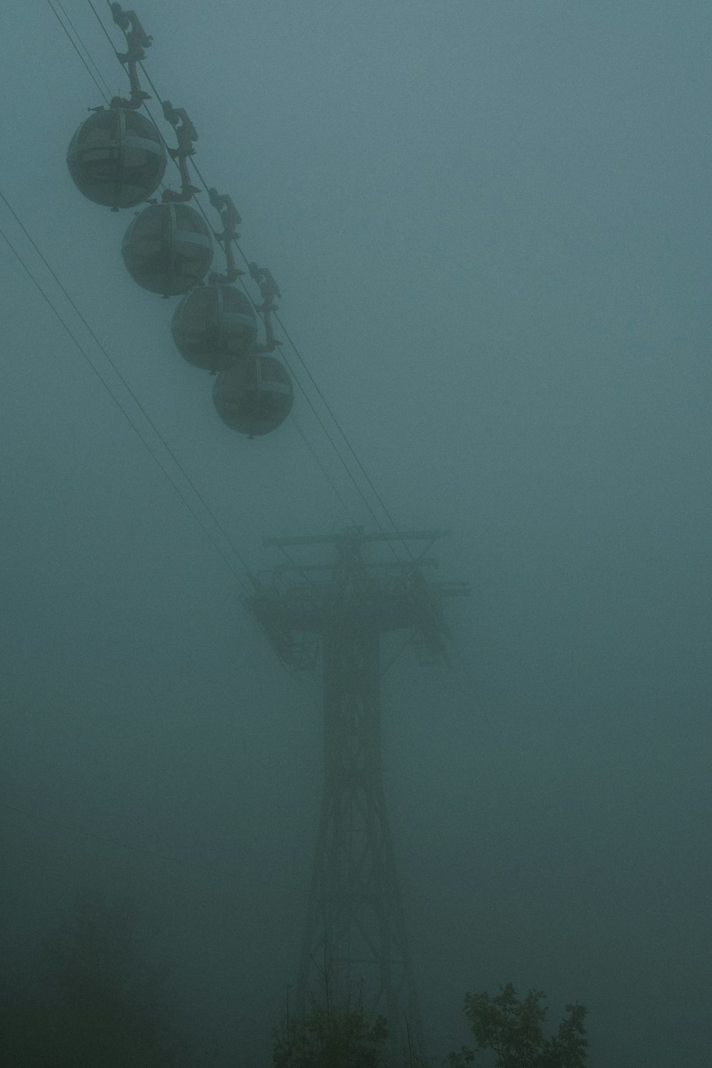 a ski lift in the fog on a foggy day