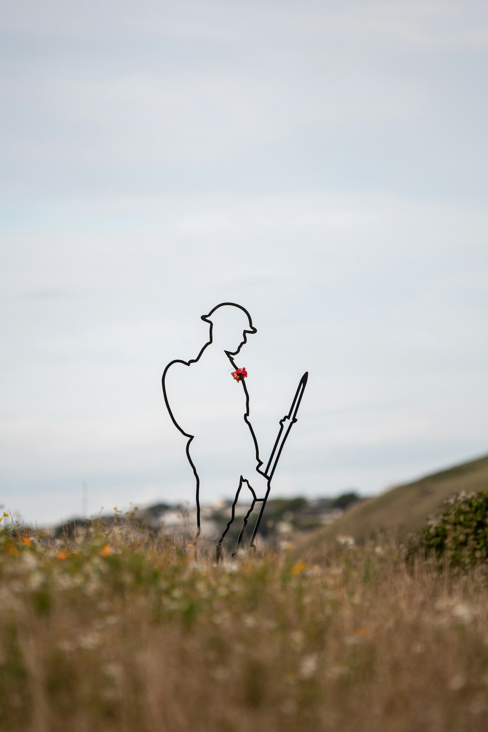 a drawing of a man holding a stick in a field