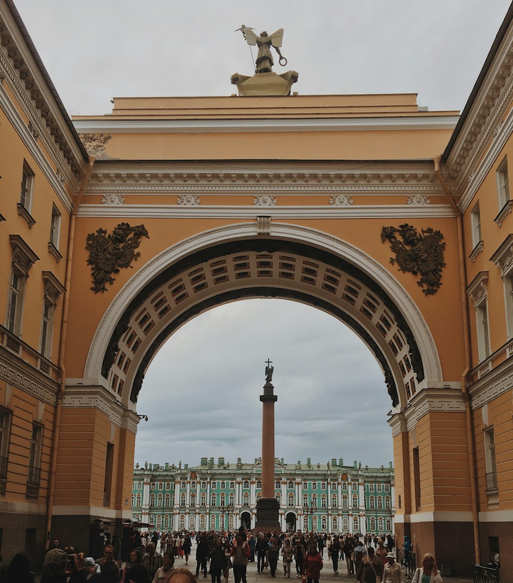 a group of people walking under an archway