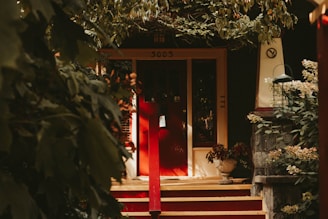 Warm terracotta-toned photo of a cozy home entrance with a visible security camera above the door.