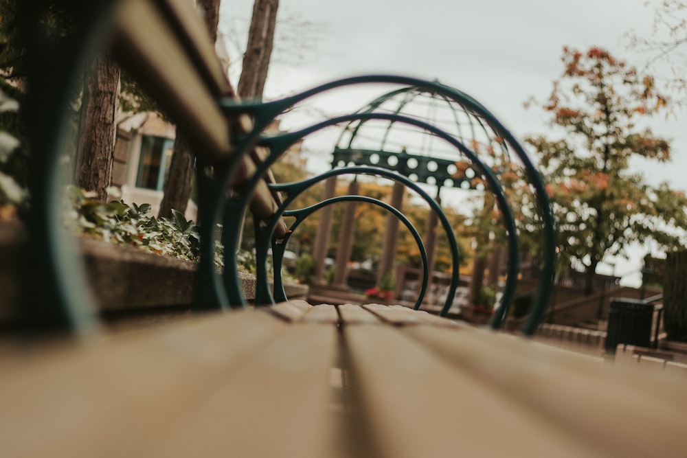 bench near trees and roofless gazebo during day