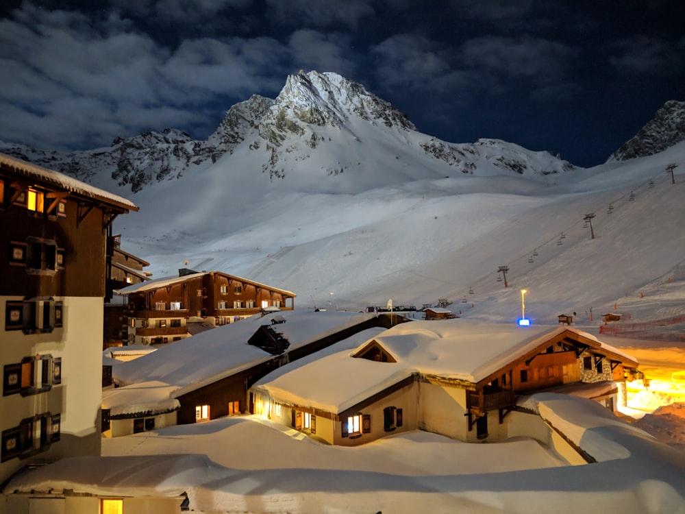 snow on top of houses roofs at night