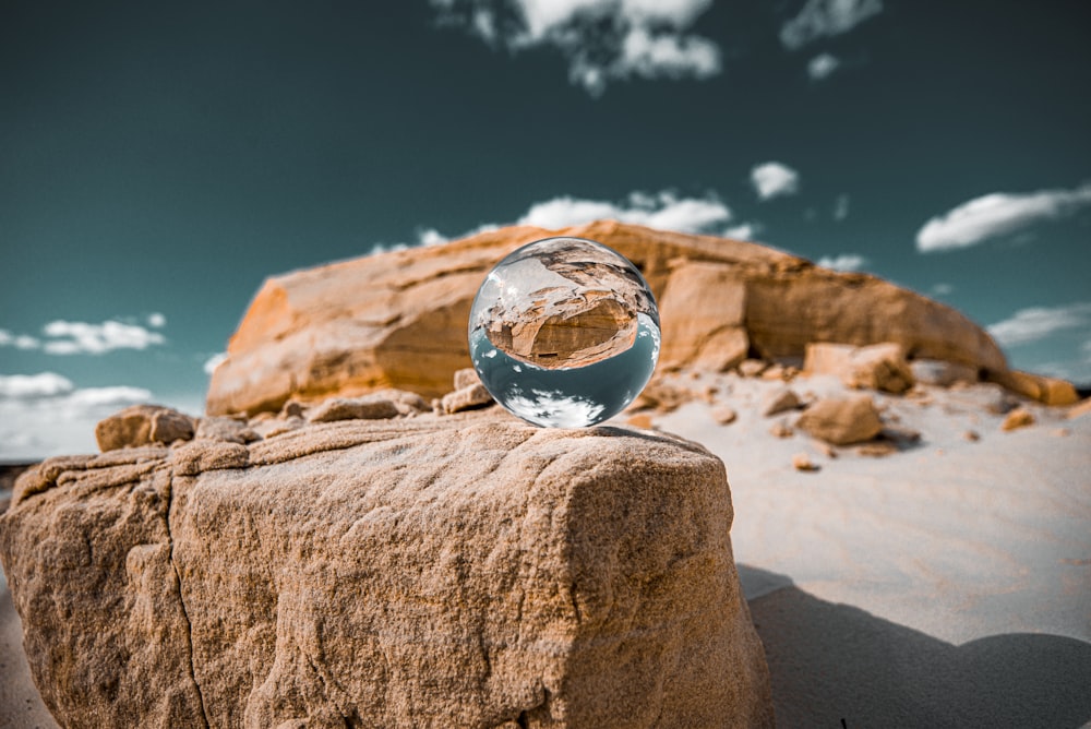 clear ball reflecting mountain during daytime