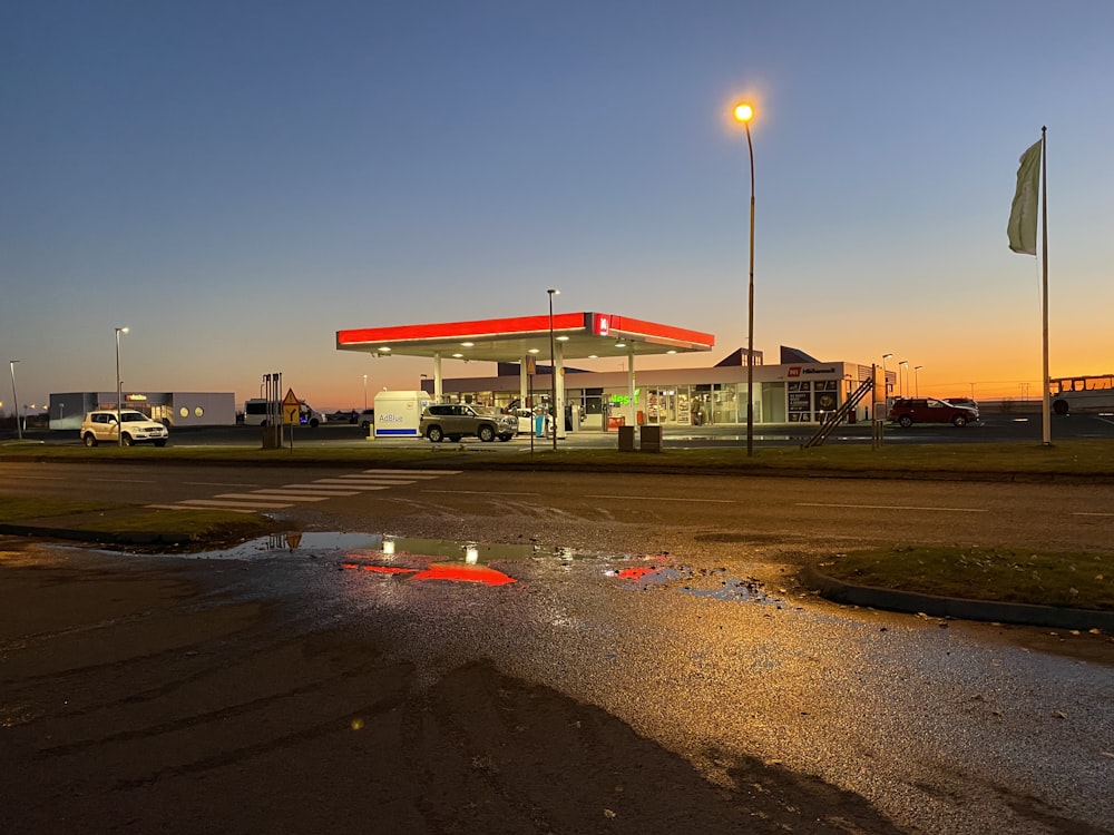 red and white gasoline station under blue sky