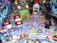 A vibrant pinball machine playfield featuring colorful graphics and electronic components, dominated by cartoonish monster figures and playful elements. The surface is densely packed with buttons, flashing lights, and ramps, creating an energetic and chaotic aesthetic.