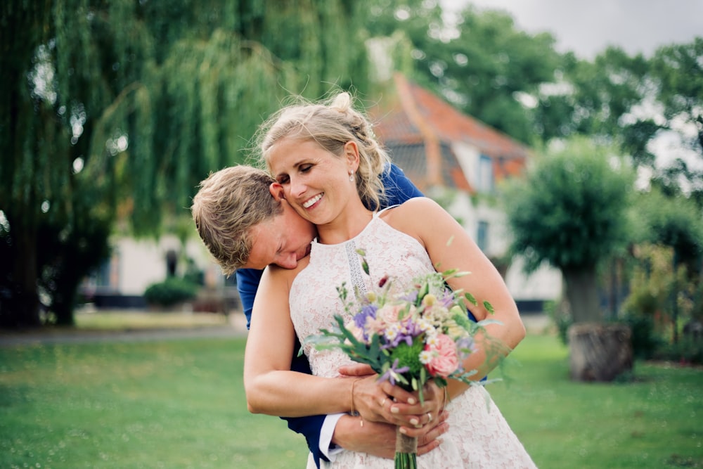 woman wearing white wedding gown and man wearing blue suit