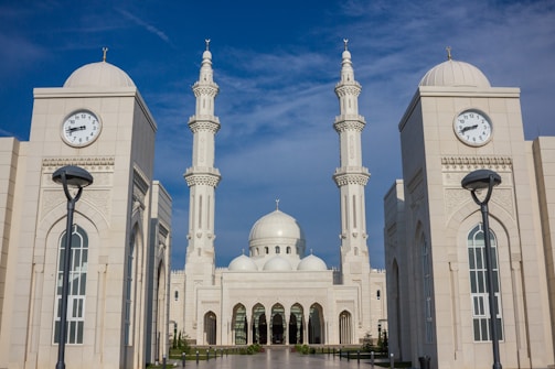 temple with two clock towers during day