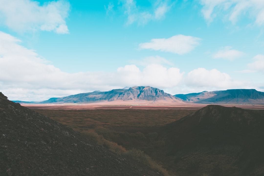 mountains under blue ccloudy sky