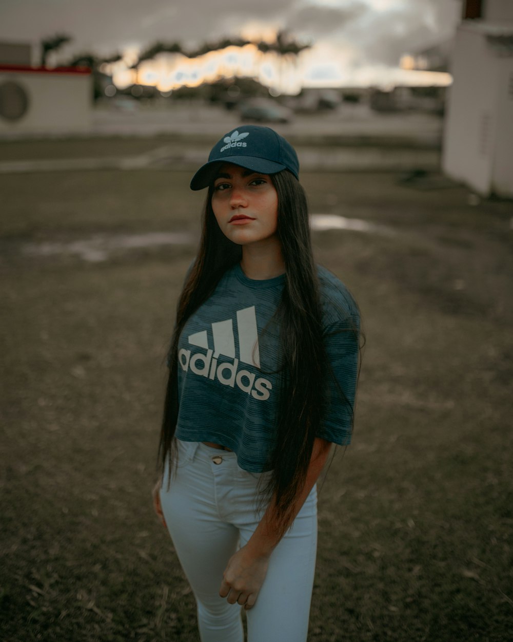 Woman in blue and white adidas crew-neck t-shirt and white jeans photo –  Free Grey Image on Unsplash