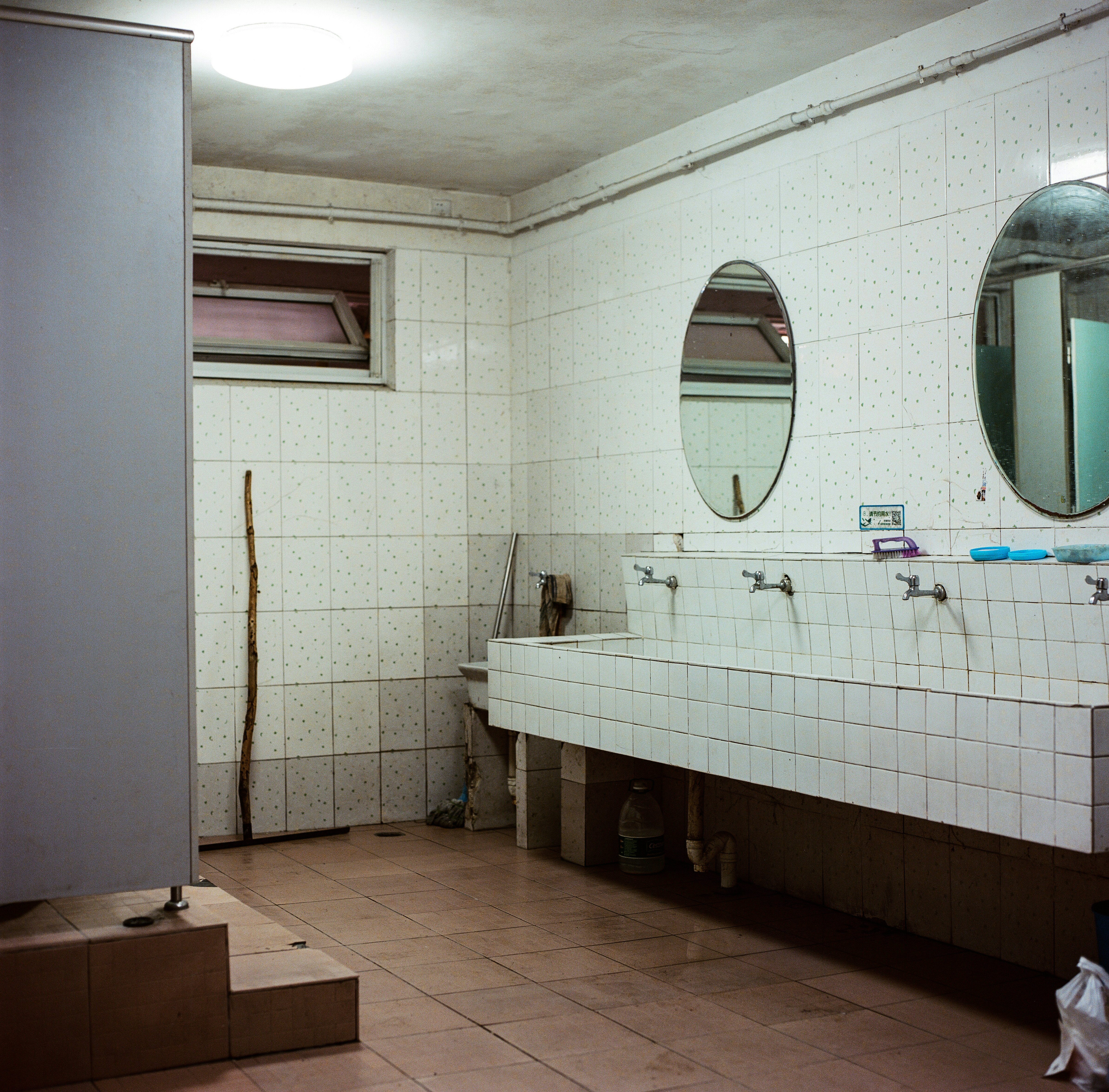 empty public restroom with lights turned on
