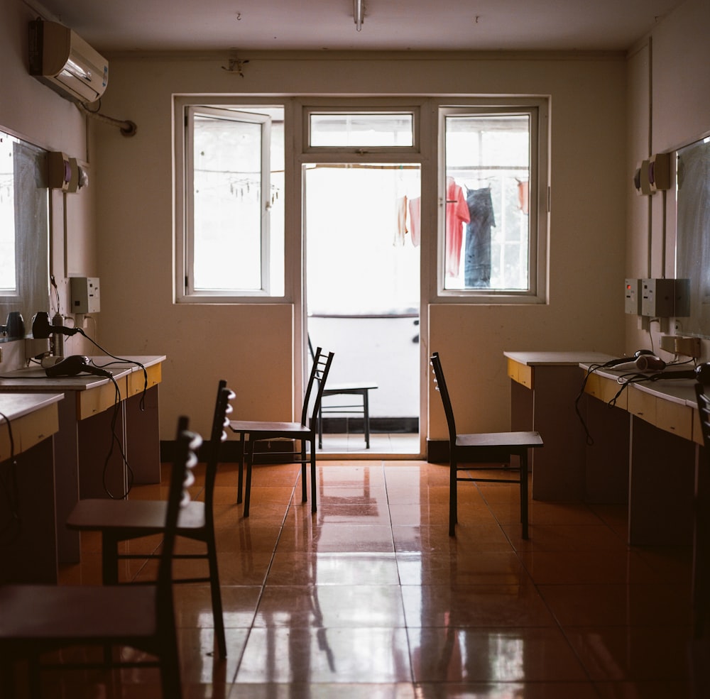 empty wooden chairs beside table