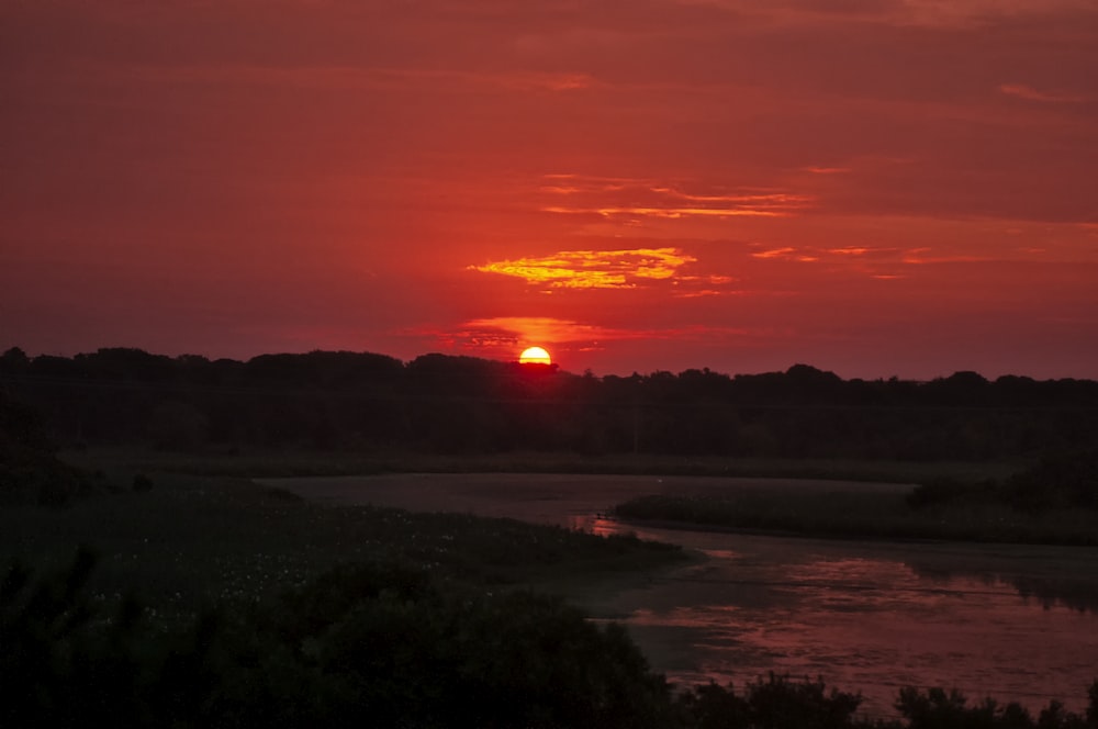 body of water during sunset