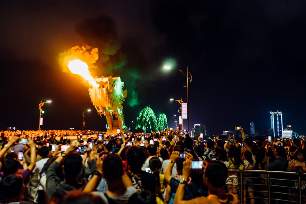 people watching fire from the tower at nighttime