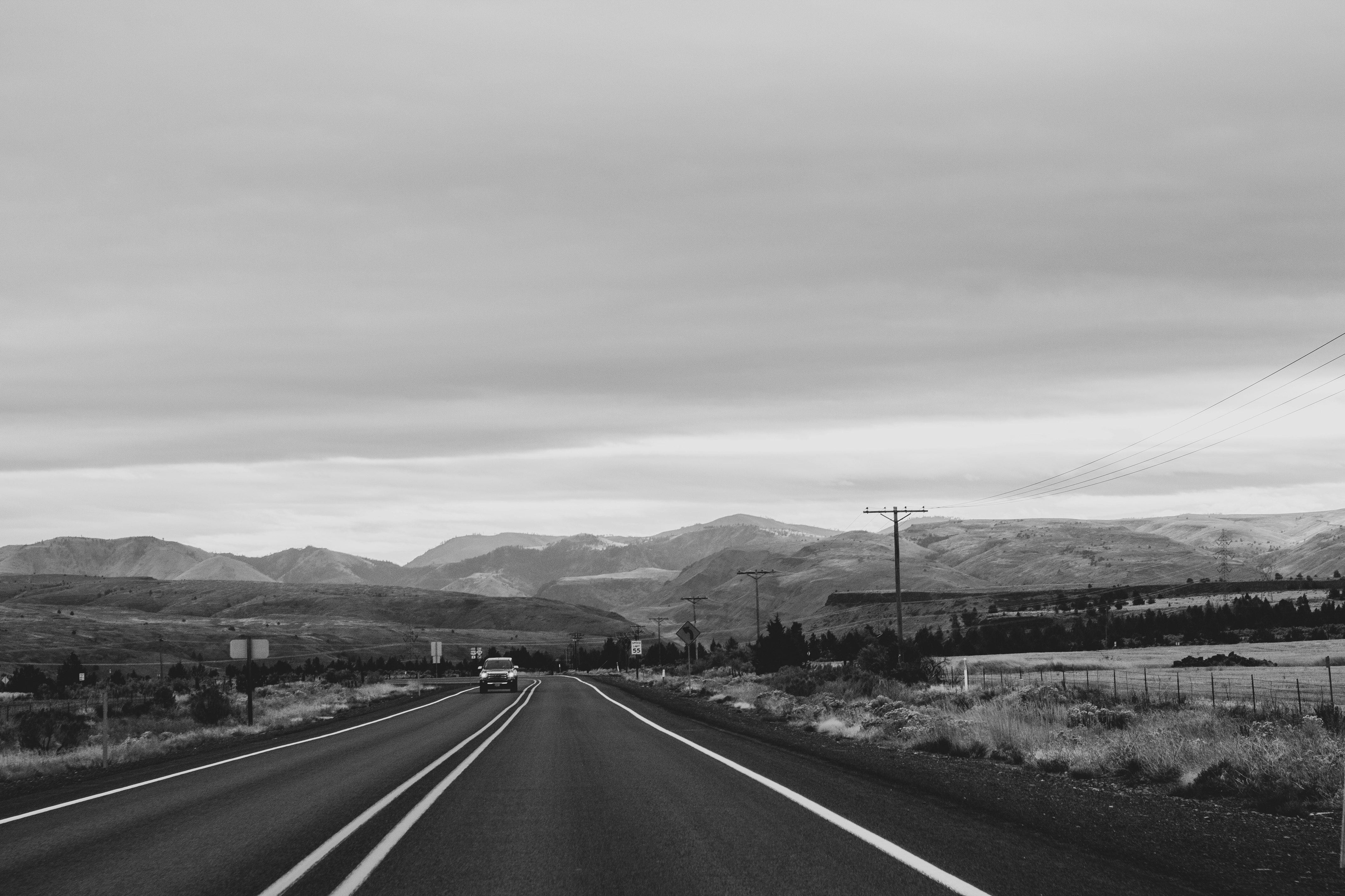 greyscale photo of car on road