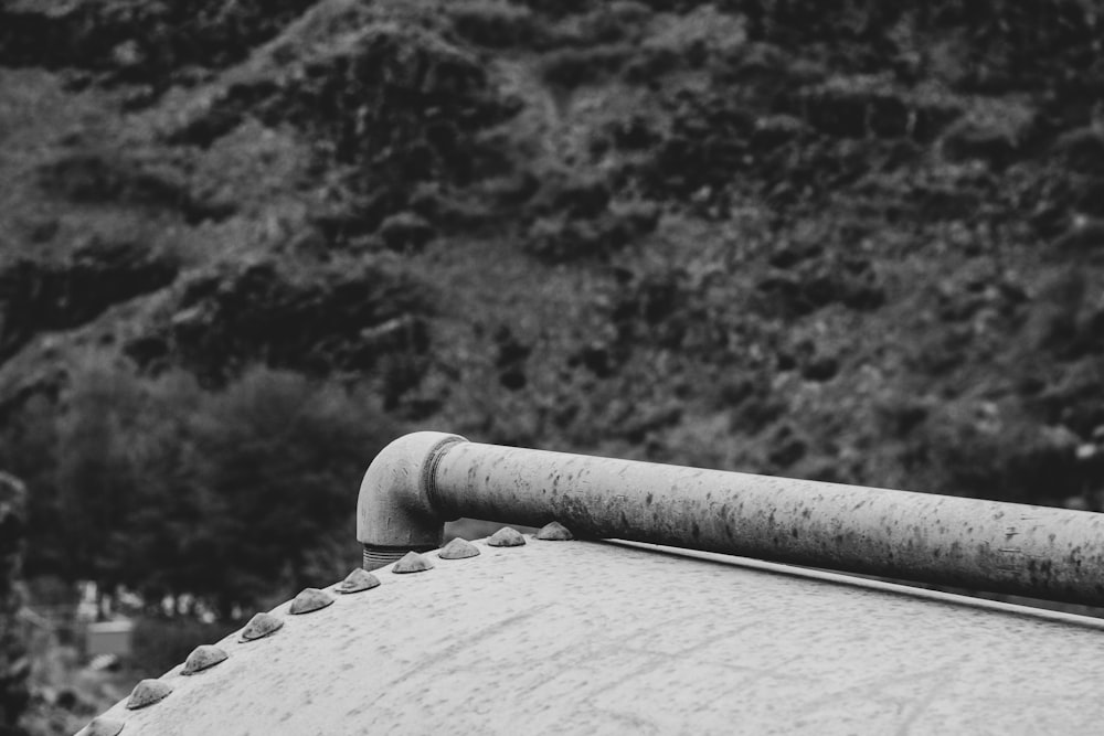 a black and white photo of a pipe on a roof