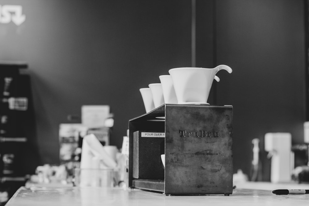 white ceramic cups on box