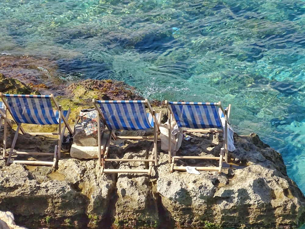 two blue chairs on cliffs
