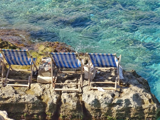 two blue chairs on cliffs in Comino Malta